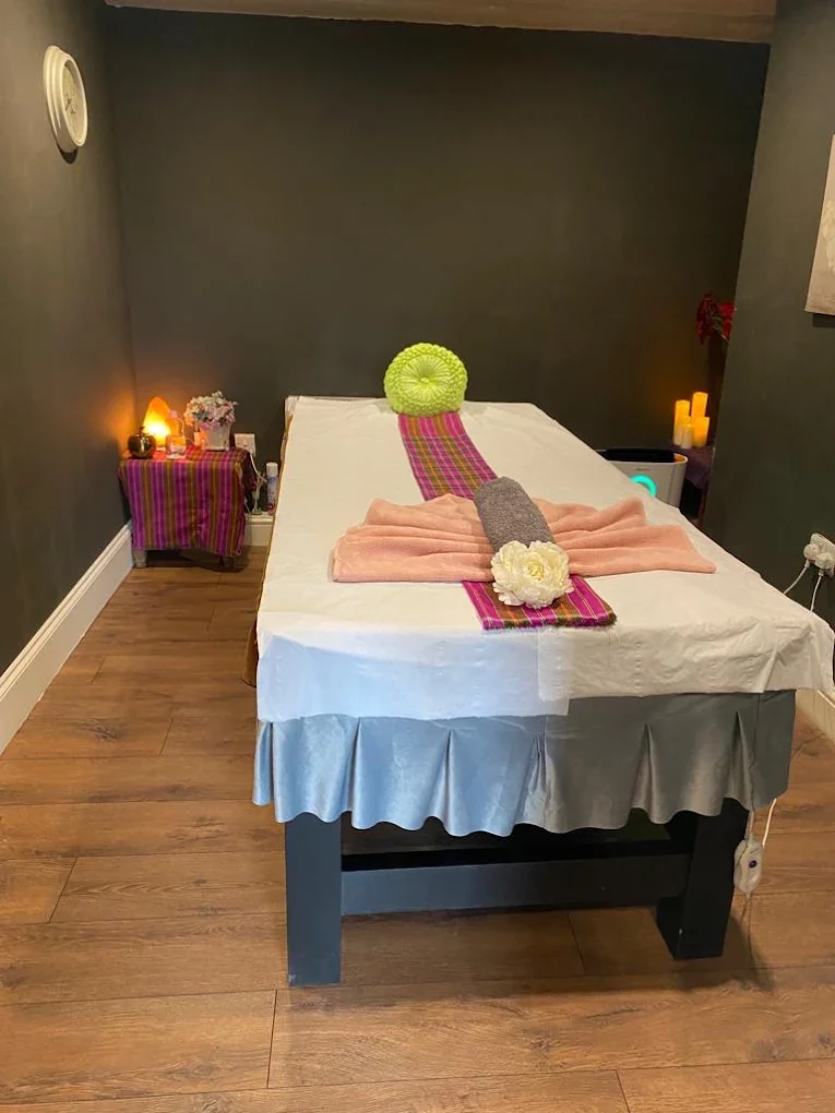 Tong Thai massage room with treatment bed and candlelight